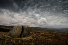 A boulder of Carboniferous age, Millstone Grit eroded and split by the action of rain and ice, the Kinder Scout Plateau, Edale, Derbyshire, England, UK, April