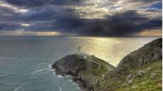 View showing lighthouse with approaching storm, South Stack RSPB reserve, Wales